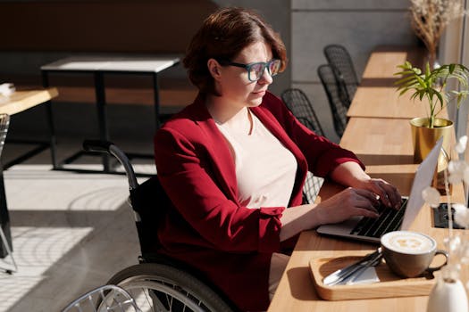 A freelancer working on a laptop in a cozy coffee shop