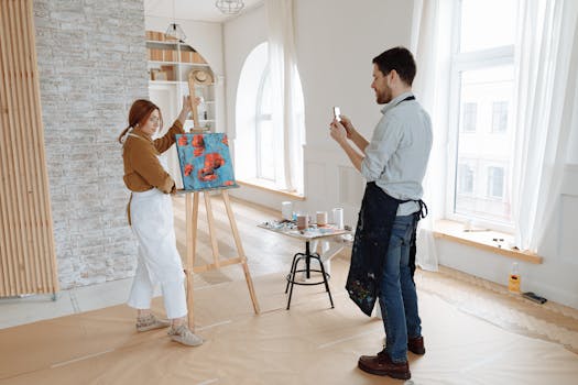 Two artists collaborating on a project in a bright studio