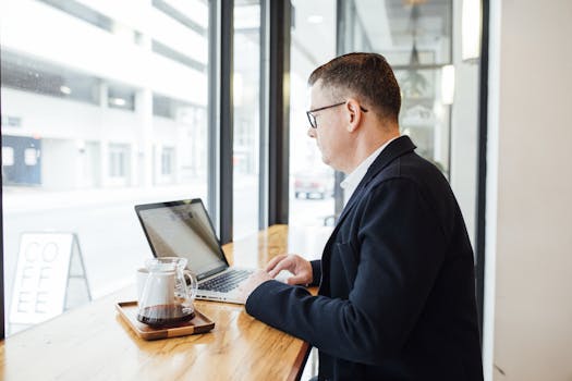 an independent contractor working on a laptop in a café