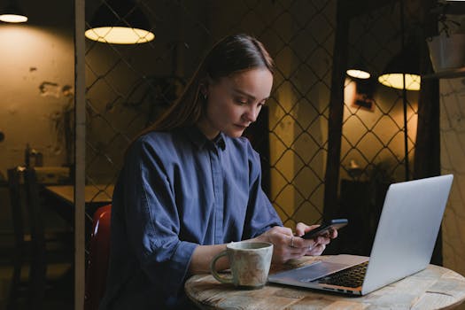 freelancer working on a laptop in a cozy coffee shop