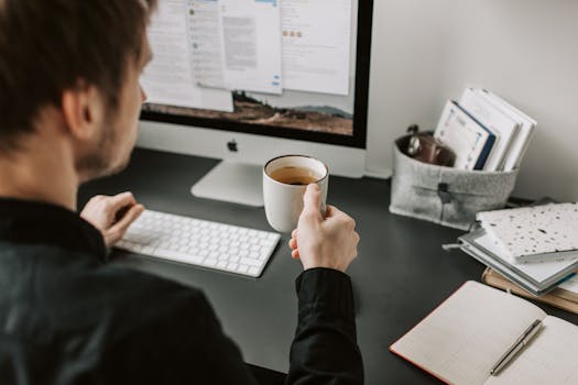 freelancer enjoying a cup of coffee while working