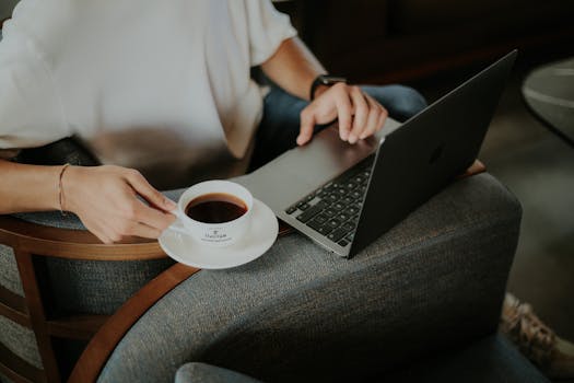 person relaxing with coffee and laptop